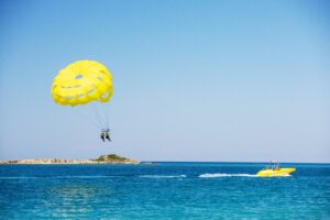 Parasailing,Above,The,Ocean.,Yellow,Parasail,Wing,Pulled,By,A