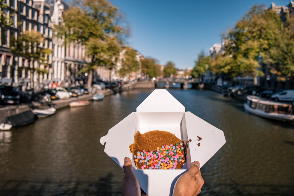 Woman,Hand,With,Stroopwafel,In,Amsterdam, ,Typical,Dutch,Food