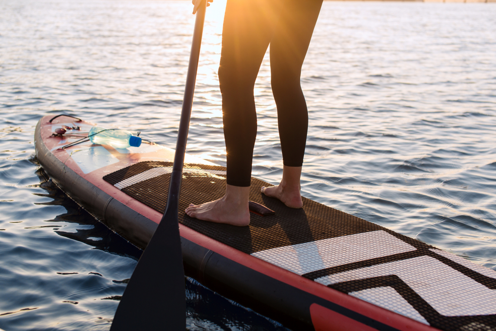 Woman,With,A,Paddle,On,The,Blackboard.,Legs,Of,A