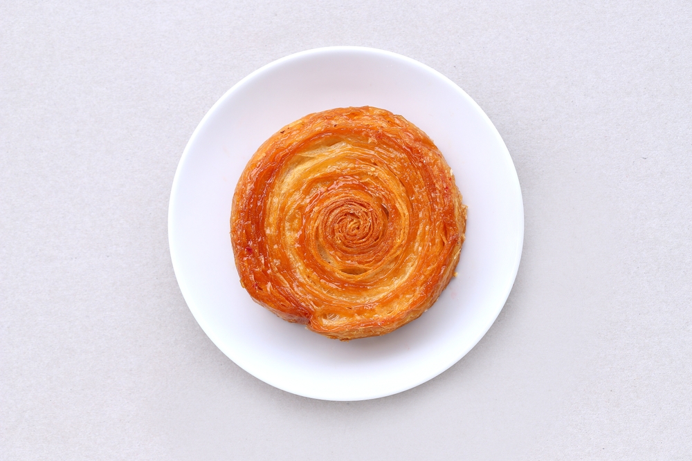 Kouign,Amann,Croissant,Served,On,Plate,Isolated,On,Light,Gray