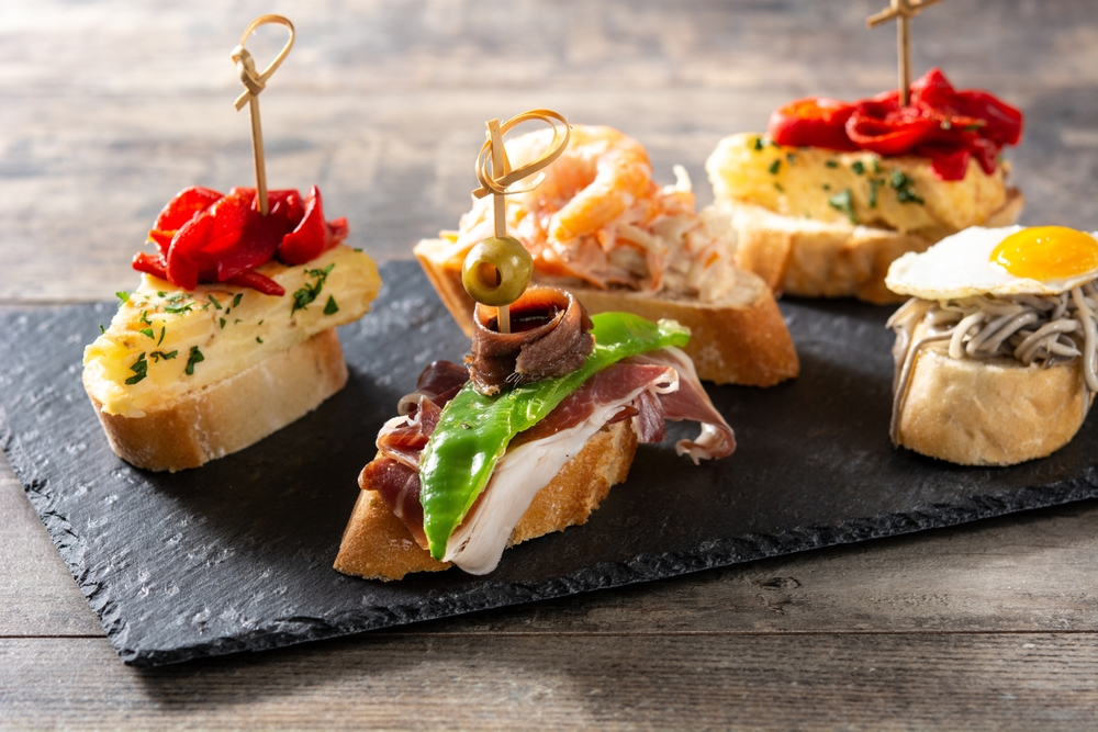 Assortment,Of,Spanish,Pintxos,On,Wooden,Table