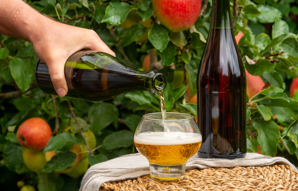 Pouring,Of,Brut,Apple,Cider,From,Normandy,In,Glass,,France