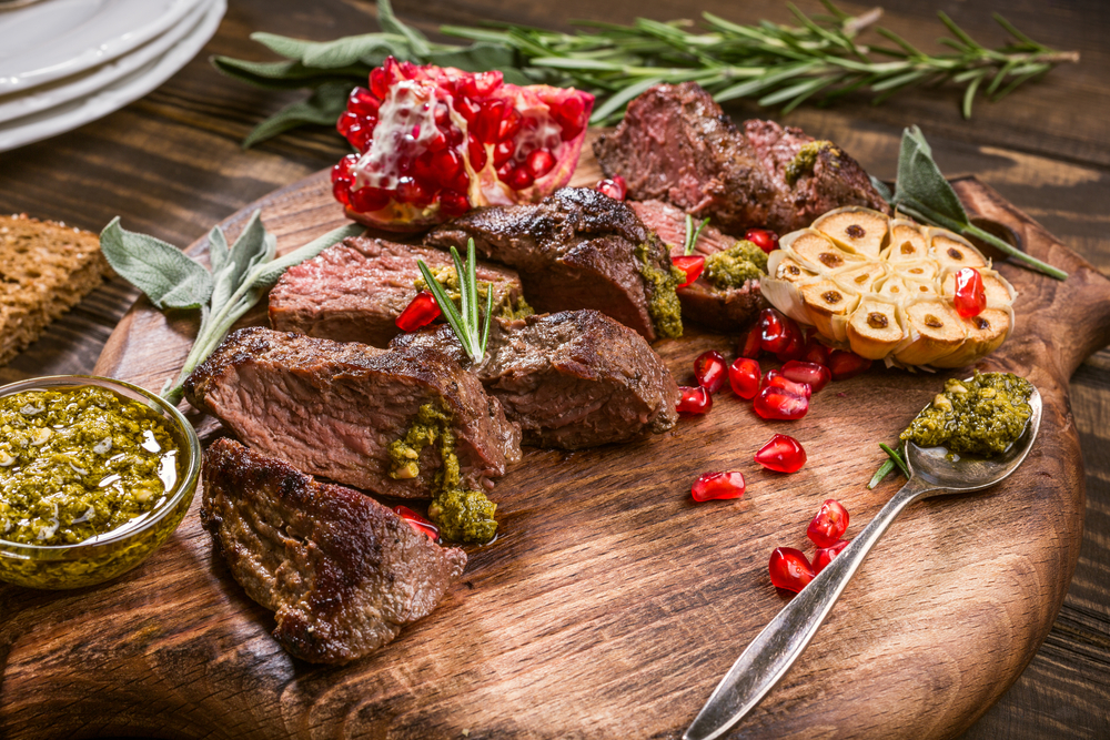 Kangaroo,Meat,Steak,With,Green,Pesto,And,Pomegranate,On,Wooden