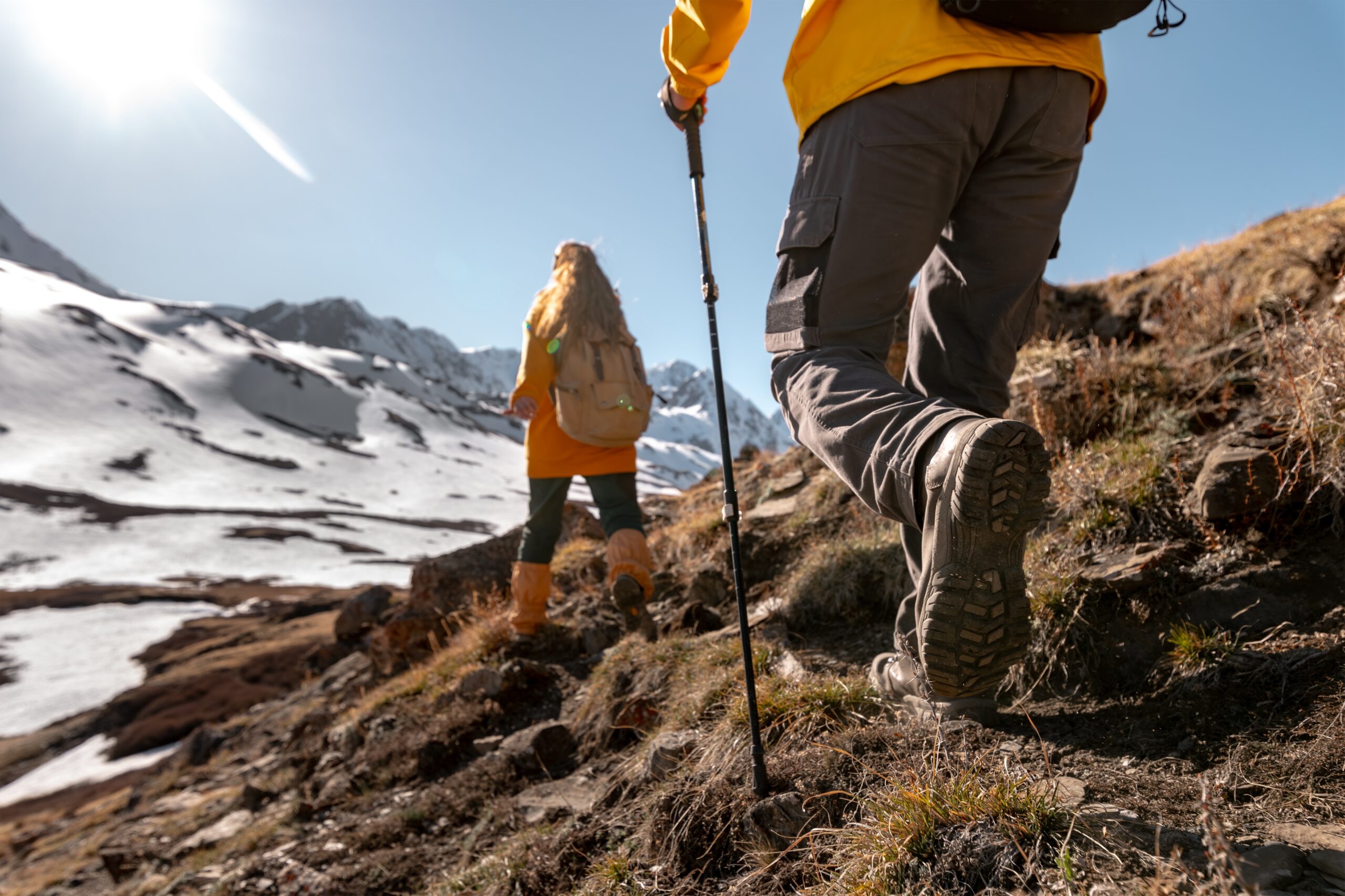 Two,Young,Active,Hikers,Walks,High,In,Mountains,With,Backpacks