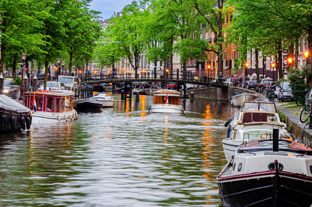 Amsterdam,,Netherlands, ,May,20,,2016:,Boat,Sailing,Through,An
