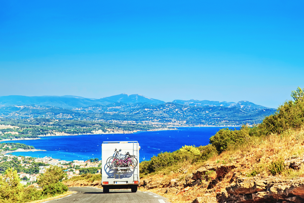 Rv,Camper,Van,Car,With,Bicycles,On,Road.,Caravan,And