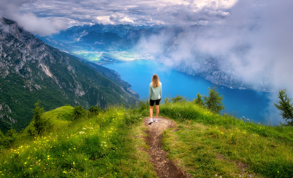 Young,Woman,On,The,Trail,On,Mountain,Peak,And,Beautiful