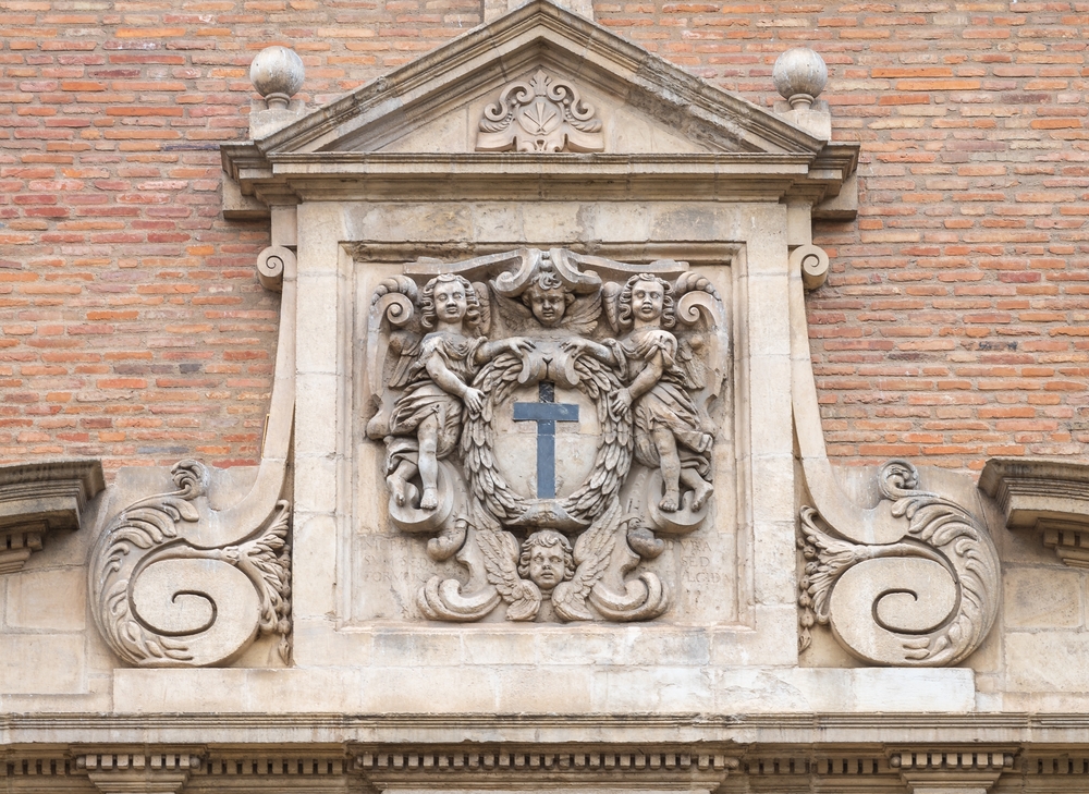 View,Of,Ancient,Stone,Carving,With,Cross,,Cherubs,And,Garland