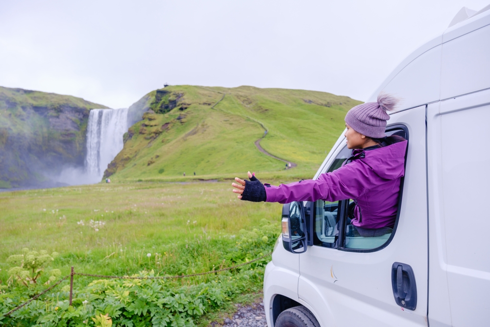 A,Traveler,Enjoys,The,Stunning,View,Of,Skogafoss,Waterfall,In